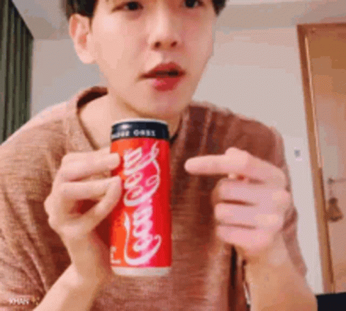 Man Holding Can of Coca Cola