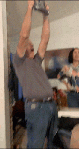 Man Holding Can Over Head GIF