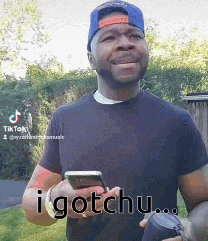 Man Holding Cell Phone Saying I Gotchu