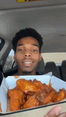Man Holding Chicken Wings And Smiling GIF