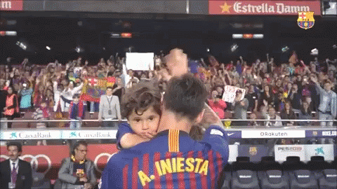 Man Holding Child In Iniesta Jersey GIF