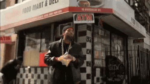 Man Holding Chips Outside Food Mart GIF