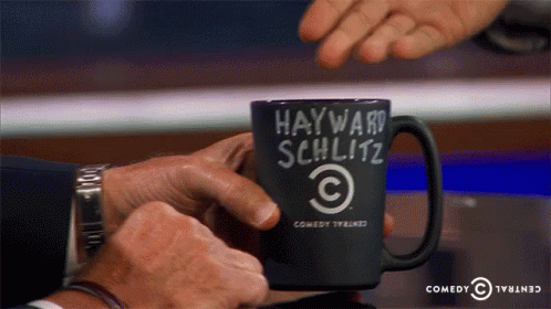 Man Holding Coffee Mug Saying Hayward Schlitz