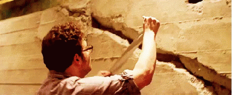 Man Holding Concrete Next To Wall GIF