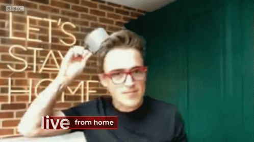Man Holding Cup in Front of Let Stay Home Sign
