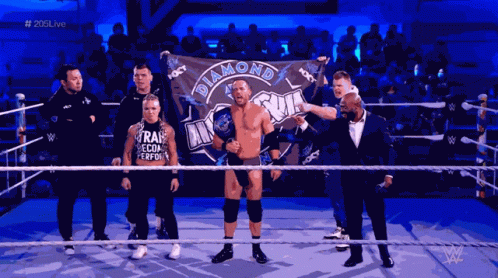 Man Holding Diamond Flag in Wrestling Ring