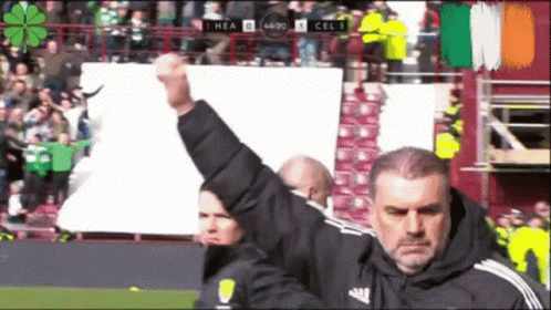 Man Holding Fist In Front Of Scoreboard GIF