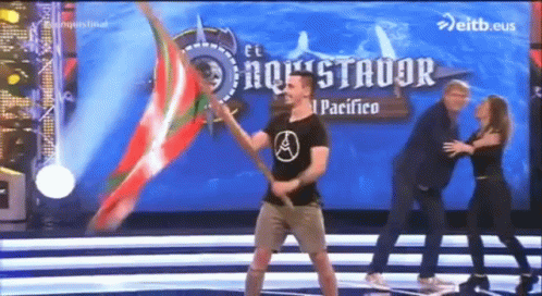 Man Holding Flag on Stage Saying El Pacifico