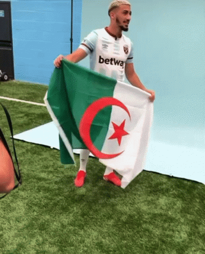 Man Holding Flag with Red Star and Green Crescent Moon