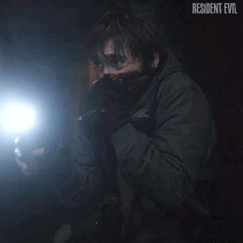Man Holding Flashlight In Dark Wearing Mask GIF