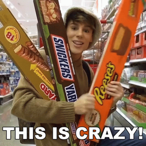 Man Holding Giant Snickers and Reese's Bars