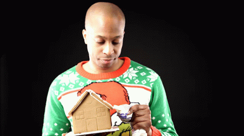 Man Holding Gingerbread House