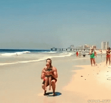 Man Holding Girl Up In The Air On Beach GIF