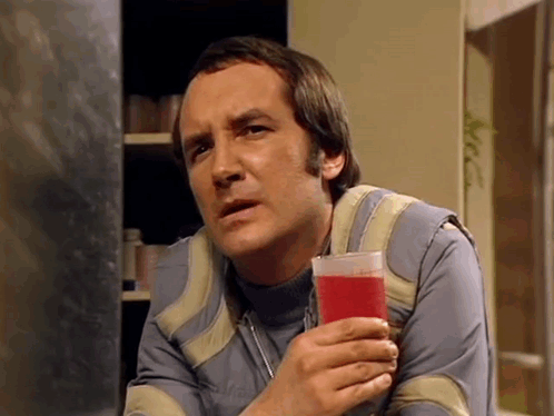 Man Holding Glass Of Red Liquid GIF