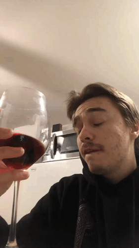 Man Holding Glass of Red Wine