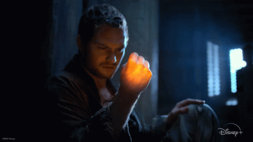 Man Holding Glowing Object with Disney Logo