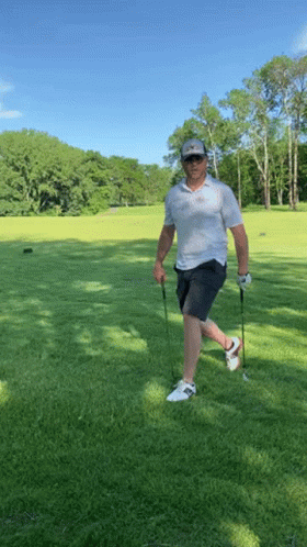 Man Holding Golf Club and Ball