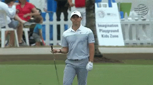 Man Holding Golf Club at Playground