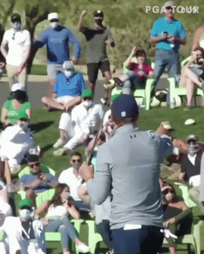 Man Holding Golf Club In Front Of Crowd GIF