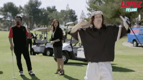 Man Holding Golf Club With Lopez TV Land Logo