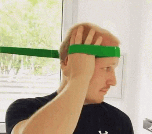 Man Holding Green Rubber Band on Head