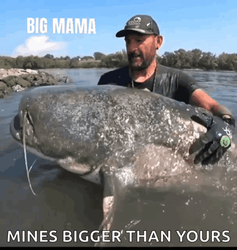 Man Holding Large Fish Saying Big Mama Mines Bigger Than Yours GIF