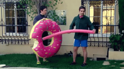 Man Holding Large Pink Donut Float GIF