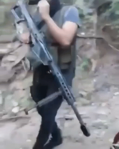Man Holding Large Rifle