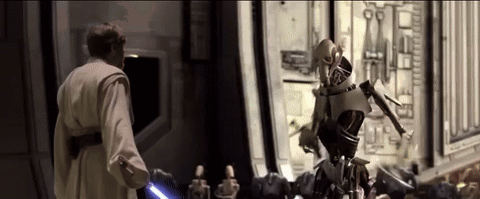 Man Holding Lightsaber Next To Robot GIF