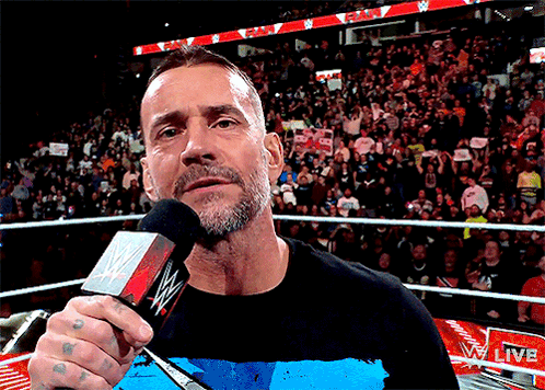 Man Holding Microphone at Live Event