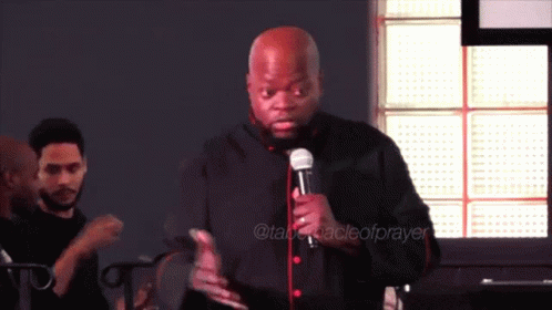 Man Holding Microphone at Prayer Sign