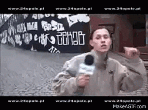 Man Holding Microphone Before Graffiti Wall Www.24opole.pl GIF