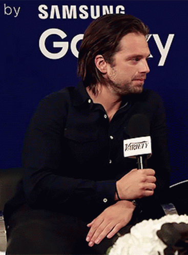 Man Holding Microphone In Front Of Samsung Sign GIF