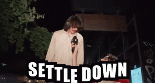 Man Holding Microphone Says Settle Down