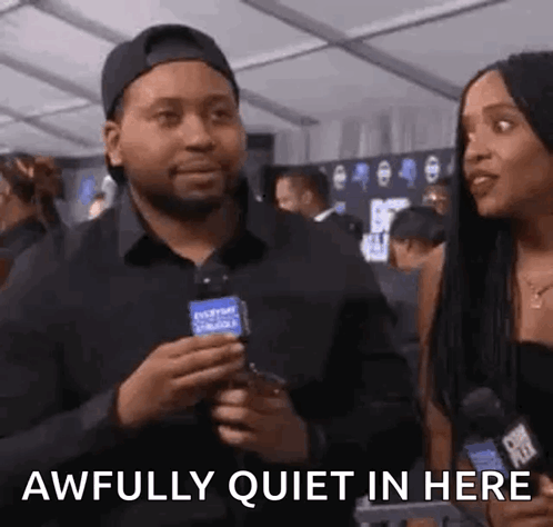 Man Holding Microphone Talking to Woman