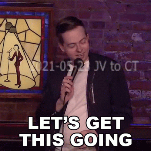 Man Holding Microphone With Let's Get This Going