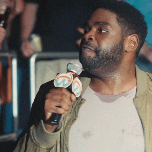 Man Holding Microphone with W