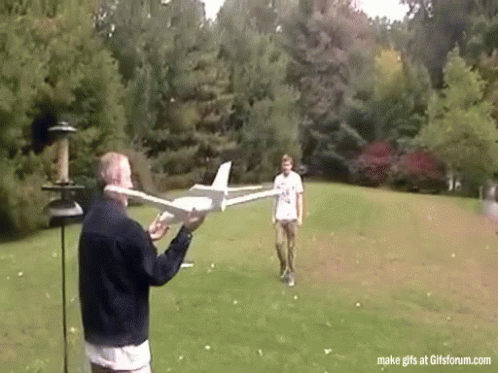 Man Holding Model Airplane and Another Looking On