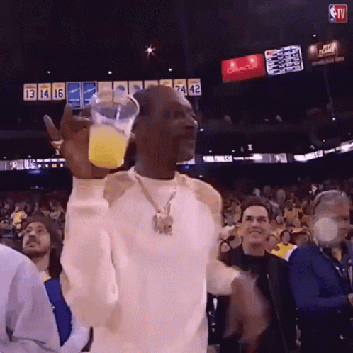Man Holding Orange Juice At Oracle Basketball Game GIF