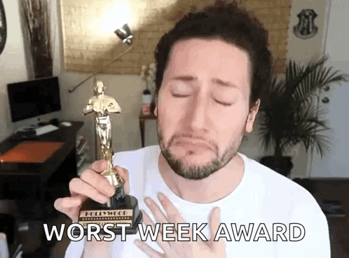 Man Holding Oscar Statue Worst Week Award
