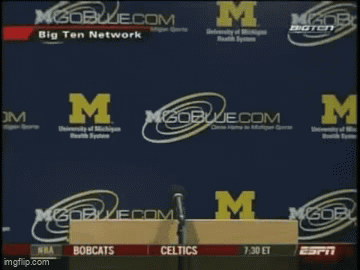 Man Holding Paper in Front of M Logo