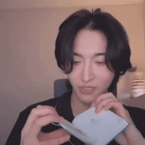 Man Holding Paper Making Face