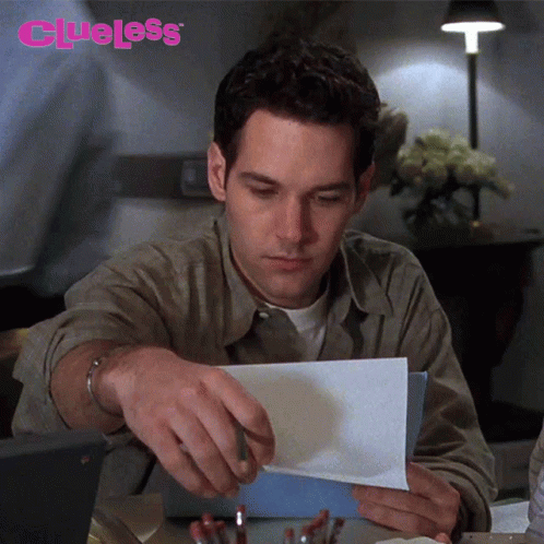 Man Holding Paper Saying Clueless