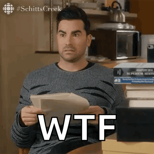 Man Holding Paper That Says WTF