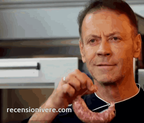 Man Holding Piece Of Meat With Reviewonivere.com Logo GIF