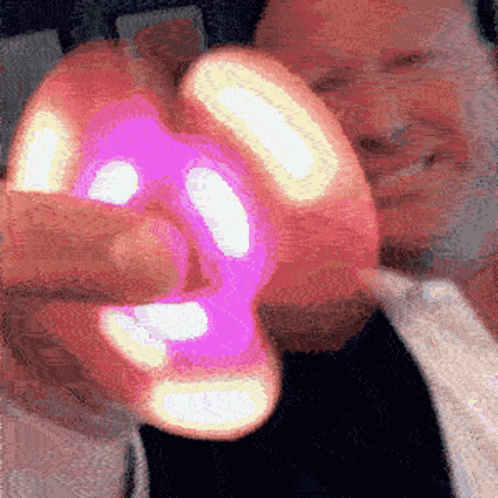 Man Holding Pink and Yellow Object