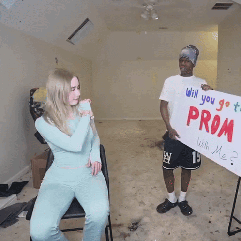 Man Holding Promposal Sign