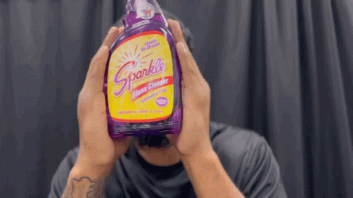 Man Holding Purple Sparkle Glass Cleaner
