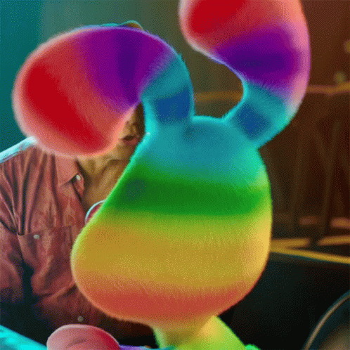 Man Holding Rainbow Stuffed Animal