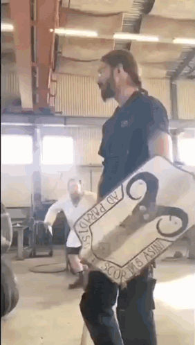 Man Holding Ram Shield